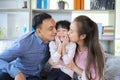 Family asian happy kiss little boy at home, young parent and children enjoy love hug