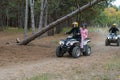 A family ATV ride through an autumn woodland Husband, wife and d