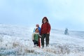 Family on autumn mountain plateau with first snow Royalty Free Stock Photo