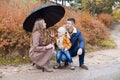 Family autumn in the Park in the rain umbrella Royalty Free Stock Photo