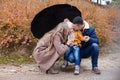 Family autumn in the Park in the rain umbrella Royalty Free Stock Photo