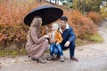 Family autumn in the Park in the rain umbrella Royalty Free Stock Photo