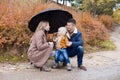 Family autumn in the Park in the rain umbrella Royalty Free Stock Photo