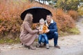 Family autumn in the Park in the rain umbrella Royalty Free Stock Photo