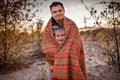 Family autumn walking. Cute girl with her father wrapping up in plaid among golden forest at fall