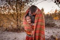 Family autumn walking. Cute girl with her father wrapping up in plaid among golden forest at fall