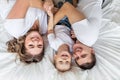 Family with baby in bed, kissing and hugging kid Royalty Free Stock Photo