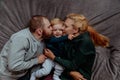 Family with baby in bed, kissing and hugging kid Royalty Free Stock Photo