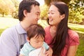 Family With Baby In Carrier Walking Through Park Royalty Free Stock Photo