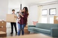 Family With Baby Carrying Boxes Into New Home On Moving Day Royalty Free Stock Photo