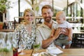 Family with baby eating food at restaurant. Royalty Free Stock Photo