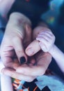 Family Baby hand, Newborn Kid hand holding onto Mother Father Parents hands, home protection concept Royalty Free Stock Photo