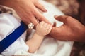 Family Baby Hands. Father and Mother Holding Newborn Kid. Child Hand Closeup into Parents Royalty Free Stock Photo