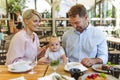 Family with baby in high chair eating food at restaurant. Royalty Free Stock Photo