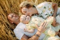 Family with baby lying and resting among wheat field Royalty Free Stock Photo