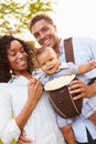 Family With Baby Son In Carrier Walking Through Park Royalty Free Stock Photo