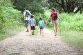 Family of back packers walking in forest