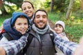 Family with backpacks taking selfie and hiking