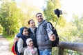 Family with backpacks taking selfie and hiking Royalty Free Stock Photo