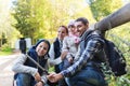 Family with backpacks taking selfie and hiking Royalty Free Stock Photo