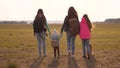 Family with backpacks travels with a dog. teamwork of a close-knit family. mother, daughters and home pets tourists Royalty Free Stock Photo