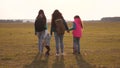 Family with backpacks travels with a dog. teamwork of a close-knit family. mother, daughters and home pets tourists Royalty Free Stock Photo