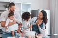 Family, baking and cooking together with high five in home kitchen with children learning from mother and father to cook Royalty Free Stock Photo