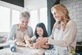 Family, baking and cooking together in a home kitchen with a mother, grandmother and child learning about food, cookies Royalty Free Stock Photo