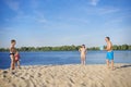 A family on the banks of the river playing volleyball on a sunny summer day.  Healthy lifestyle Royalty Free Stock Photo