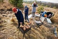 Family barbecuing on a deck in the pine forest. Bbq day with grill Royalty Free Stock Photo