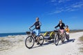 Family on a beach bicycle ride together Royalty Free Stock Photo