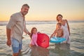 Family, beach and body board, kids with parents in water on summer holiday. Mom, dad and children surfing in ocean at Royalty Free Stock Photo