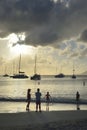 Family on the beach at Cane Garden Bay with boats in the background, Tortola, BVI Royalty Free Stock Photo