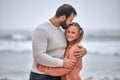 Family, beach and father kiss girl on vacation, holiday or trip outdoors. Love, care and affection hug of dad and kid Royalty Free Stock Photo