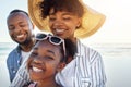 Family beach vacations are kinda our thing. an adorable little girl having fun with her parents on the beach.