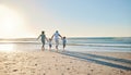 Family, beach walking and holding hands with mother, father and kids by the ocean on holiday. Vacation, love and parent Royalty Free Stock Photo
