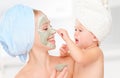 Family beauty treatment in bathroom. mother and daughter baby g