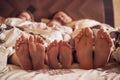 Family on the bed at home with their feet showing Royalty Free Stock Photo