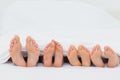 Family on the bed showing their feet Royalty Free Stock Photo