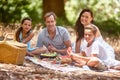 This family believes in the power of happy. a happy family having a picnic in the forest.