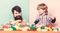 Family is Best. small boy with dad playing together. happy family leisure. father and son play game. building home with