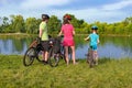 Family bike ride outdoors, active parents and kid cycling and relaxing outdoors near beautiful river, family sport Royalty Free Stock Photo