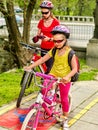 Family bike ride with rucksack cycling on bike lane. Royalty Free Stock Photo