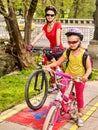 Family bike ride with rucksack cycling on bike lane. Royalty Free Stock Photo