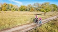 Family on bikes autumn cycling outdoors, active mother and kid on bicycles, aerial view of happy family with child in fall park Royalty Free Stock Photo