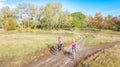 Family on bikes autumn cycling outdoors, active mother and kid on bicycles, aerial view of happy family with child in fall park Royalty Free Stock Photo