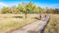 Family on bikes autumn cycling outdoors, active mother and kid on bicycles, aerial view of happy family with child in fall park Royalty Free Stock Photo