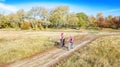 Family on bikes autumn cycling outdoors, active mother and kid on bicycles, aerial view of happy family with child in fall park Royalty Free Stock Photo