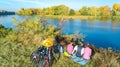 Family on bikes autumn cycling outdoors, active parents and kid on bicycles, aerial view of happy family with child relaxing Royalty Free Stock Photo