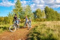 Family on bikes cycling outdoors, active healthy parents and kids riding bicycles, family sport and fitness Royalty Free Stock Photo